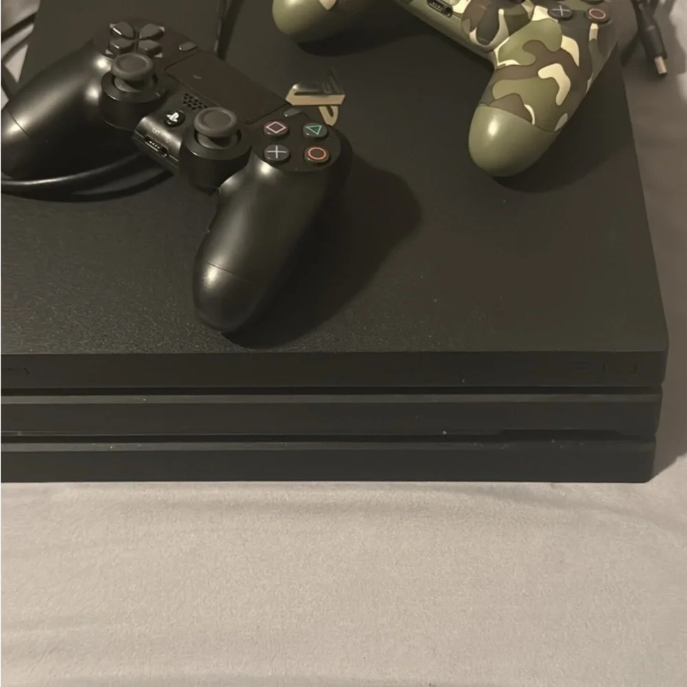 Sony Console with Black and Camouflage Controllers